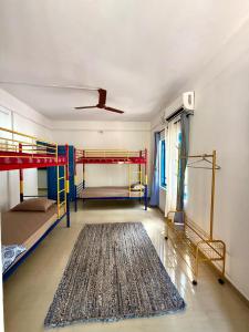 a room with two bunk beds and a rug at Dive home Agatti in Agatti