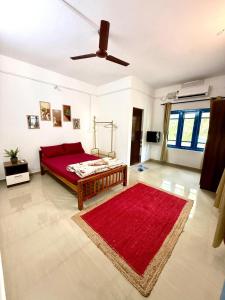 a bedroom with a red bed and a red rug at Dive home Agatti in Agatti