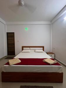 a bedroom with a large bed in a room at Dive home Agatti in Agatti