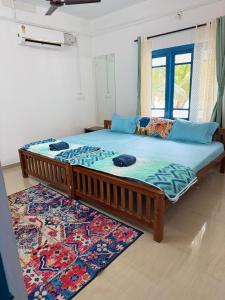 a large bed in a room with a window at Dive home Agatti in Agatti