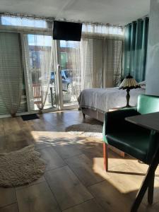 a bedroom with a bed and a table and a chair at Piccolo in Knin