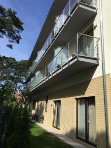 a building with a balcony on the side of it at Villa Amelia in Niechorze