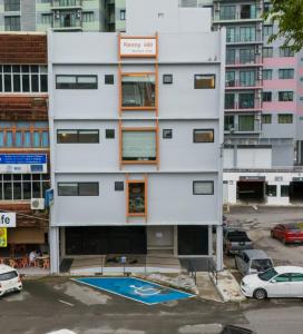an apartment building with a pool in front of it at Kenny Hill Boutique Hotel near Borneo Medical Centre Kuching in Kuching