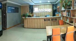 ein Restaurant mit einer Theke und Stühlen in einem Zimmer in der Unterkunft Jun Hotel Jiangsu Nanjing Gulou District Gupinggang in Nanjing