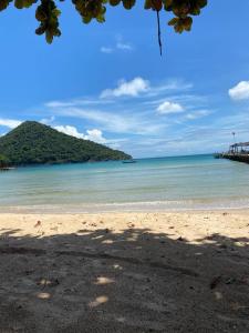 a view of a beach with a pier and the ocean at Big Head Bungalows in Koh Rong Sanloem