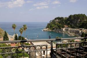 a view of the ocean from a balcony at Cottage on the Beach in Taormina