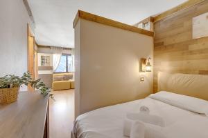 Ένα ή περισσότερα κρεβάτια σε δωμάτιο στο Abeti Ski Apartments