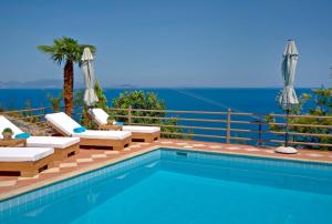a swimming pool with a view of the ocean at Blue Horizon Suites in Paralion astros