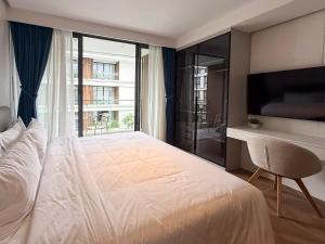 a bedroom with a large bed and a large window at Sunshine Layan Beach Resort studio #84191 in Layan Beach +26 photos
