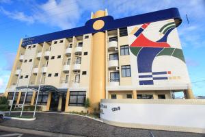 a building with a mural on the side of it at Real Praia Hotel in Aracaju