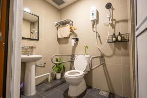 a bathroom with a toilet and a sink at Kenny Hill Boutique Hotel near Borneo Medical Centre Kuching in Kuching +23 photos