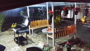 a patio with two benches and a piano at Tea Hills Bungalow in Hatton