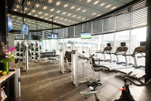 a gym with several treadmills and exercise bikes at Hotel Las Americas Golden Tower Panamá in Panama City