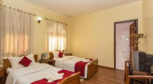 Postel nebo postele na pokoji v ubytování Hotel Norbu Sangpo