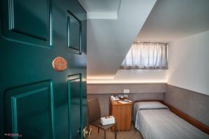 Hotel Villa Giulia tesisinde bir odada yatak veya yataklar