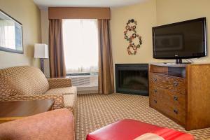 a living room with a flat screen tv and a fireplace at GrandStay Inn & Suites of Luverne in Luverne