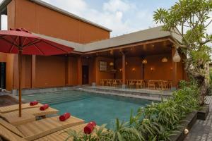 a swimming pool in front of a building at Nauma Ubud Villa in Ubud