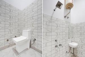 a white bathroom with a toilet and a sink at Hotel O Meerut Central College Formerly Saffron in Meerut