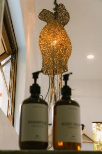two bottles of soap sitting on a counter with a lamp at SAMPA El Nido in El Nido +68 photos