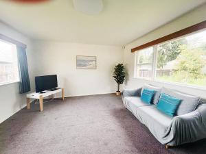 a living room with a couch and a tv at Peaceful Home Near Gardens, University & Downtown in Hamilton