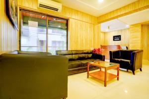 a living room with a couch and a table at Palette Hotel And Resort Igatpuri Formerly Bodh Valley Resort in Igatpuri
