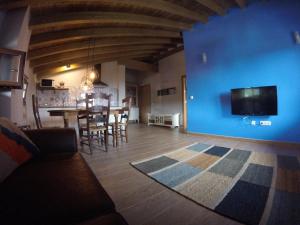 sala de estar con mesa y pared azul en Etxekone, en Guernica y Luno
