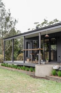 a modern house with a glass facade at Riverfront Luxury Stay Tiny House Sauna and Bath in Old Bar