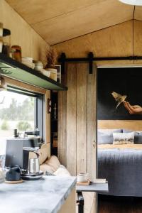a view of a kitchen in a tiny house at Riverfront Luxury Stay Tiny House Sauna and Bath in Old Bar