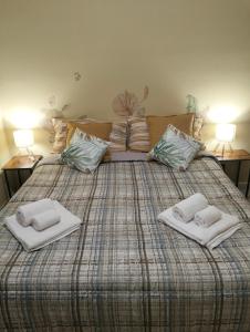 a large bed with two white pillows on it at GLI ELEMENTI Affittacamere Pieve Emanuele - HUMANITAS, IEO, MILANO CENTRO E FORUM ASSAGO in Pieve Emanuele +44 photos