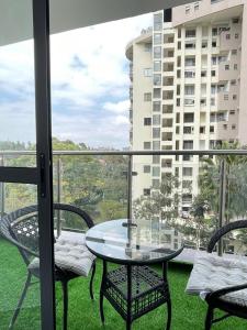 a balcony with a table and chairs and a building at 2 bedrooms apartment in Riverside drive in Nairobi