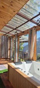 a large bathroom with a view of a bridge at Skyview Jacuzzi Treehouse Power Backup Tandi in Kulu