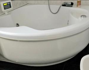 a white toilet in a bathroom with a clock on the wall at Casa Orchidea a La Spezia in La Spezia