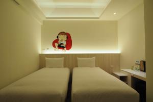 Postel nebo postele na pokoji v ubytování M Hotel