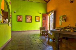 a room with green walls and a table in it at Hotel La Posada del Sol in Granada