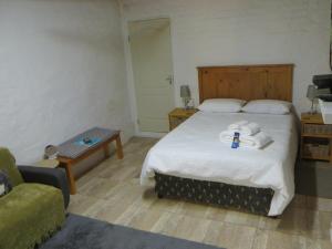 En eller flere senge i et værelse på Country Cottages