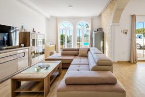 a living room with a couch and a table at Utković Beachfront Apartments in Vrsi