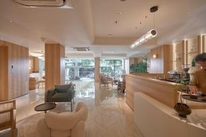 a kitchen and living room with a table and chairs at Amaya Saigon Boutique Hotel in Ho Chi Minh City