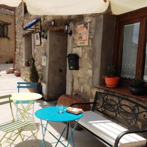 a patio with a table and chairs and a bench at Ana de las Tejas Azules in Medinaceli