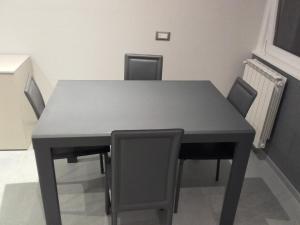 una mesa negra y sillas en una habitación en Appartamento Wow en Cannero Riviera