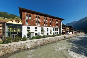 ein Gebäude an der Seite eines Flusses in der Unterkunft Hotel Garni Sunshine in Sölden