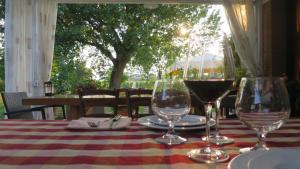 a table with two glasses of wine on it at Agriturismo L'Albara - Wines, Pool & SPA in Villaganzerla