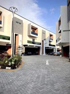 a parking lot in front of a large building at Cozy Apartment in Lekki in Lekki