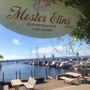 a sign for a marina with boats in the water at Unique Mongolian Yurt near lake together with guest house in Hjo +21 photos