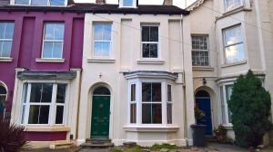 a row of colourful houses with a green door at Regent Serviced Suites in Doncaster