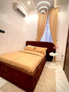 a bedroom with a bed and a window at Cozy Apartment in Lekki in Lekki +17 photos