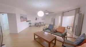 a living room with a couch and a table at Qingdao Donghai Hotel in Qingdao +172 photos