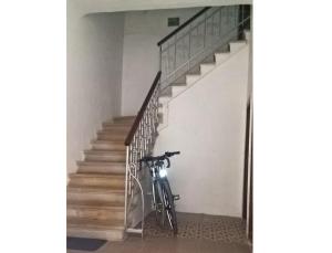 a bike parked in a hallway next to a staircase at San Eleuterio Guesthouse in Poreč