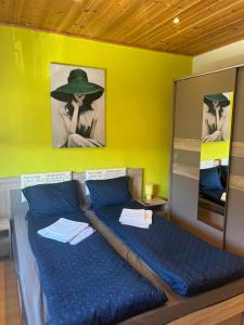 a bedroom with a bed with a hat on it at The Old Cherry House in Razlog