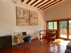 a living room with a table and a desk at Villa Valentina in Bracciano