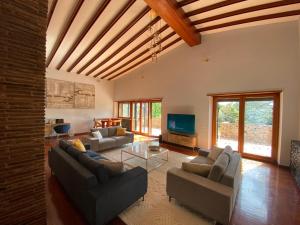 a living room with two couches and a tv at Villa Valentina in Bracciano